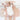 Baby lying comfortably on toddlekind baby portable changing clutch mini maven blush with quilted cushioning.