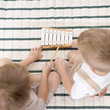 Overhead view of children playing xylophone on striped cushioned mat – toddlekind portable water resistant wander grande play mat forest for interactive play