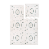 Interlocking foam tiles with one tile lifted to show puzzle edges of the toddlekind baby toddler foam modern designer puzzle play mat haven amira seagrass.