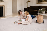 Parent and child drawing together on the Toddlekind Aria Maple Playmat in a bright living room, showcasing the spacious cushioned play surface.
