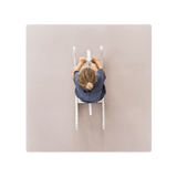 Minimal lifestyle shot of child riding toy on toddlekind baby toddler foam modern puzzle play mat classic blush. Alt Img