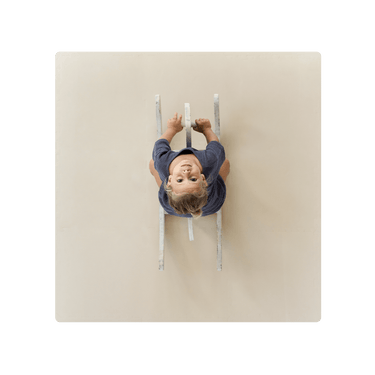 Overhead view of child on ride-on toy on toddlekind baby toddler foam modern puzzle play mat classic clay. Alt Img