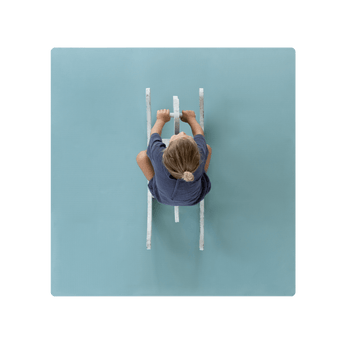 Overhead view of toddler riding toy on toddlekind baby toddler foam modern puzzle play mat classic mineral in soft blue-green tone. Alt Img