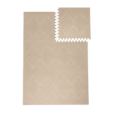 Interlocking tile layout with one piece removed showing the toddlekind baby toddler foam modern designer puzzle play mat haven tulum dessert caliza.