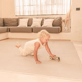 Toddler crawling and playing with a toy car on the toddlekind baby toddler foam modern designer puzzle play mat haven deco latte.