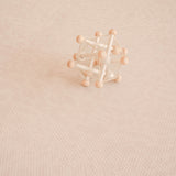 wooden toy sitting on close up image of toddlekind haven foam puzzle play mat in wild dune