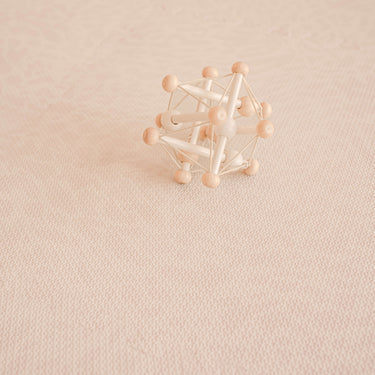 wooden toy sitting on close up image of toddlekind haven foam puzzle play mat in wild dune