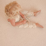 child sitting on toddlekind haven foam puzzle play mat in wild dune