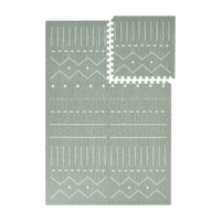 Interlocking green foam tiles with one tile removed from toddlekind baby toddler foam modern designer puzzle play mat haven berber moss.