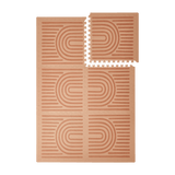 Interlocking tiles arranged in a grid with one corner lifted showing the toddlekind baby toddler foam modern designer puzzle play mat haven linear camel.