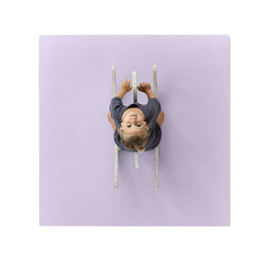 Overhead view of toddler on ride-on toy centered on toddlekind baby toddler foam modern puzzle play mat classic lilac. Alt Img