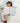 Baby lying on toddlekind baby portable changing clutch mini maven slate with soft cushioned changing surface.