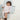 Baby lying on toddlekind baby portable changing clutch mini maven slate with soft cushioned changing surface.