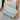 Folded toddlekind baby portable changing clutch mini maven slate held in hands showing compact portable form.