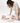 Parent changing baby on toddlekind baby portable changing clutch mini maven blush opened flat for easy diapering.