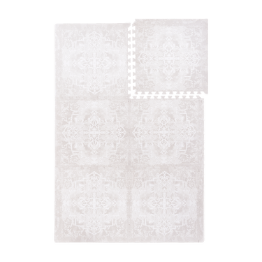 Interlocking foam tiles with one tile lifted to show puzzle edges of the toddlekind baby toddler foam modern designer puzzle play mat haven parisa millet.