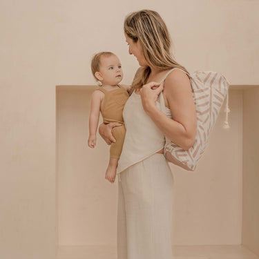 Mother holding baby with drawstring carry bag over shoulder – toddlekind portable water resistant wander classic play mat ocean sea shell for easy portability