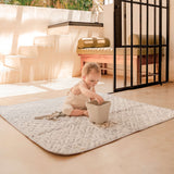 Baby sitting on leaf-pattern play mat outdoors playing with toys – toddlekind portable water resistant wander classic play mat ocean stone for indoor and outdoor play
