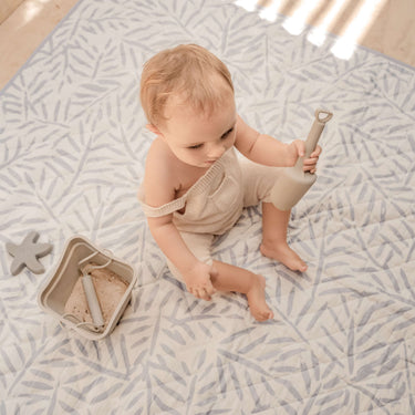 Top view of baby playing with toys on spacious mat – toddlekind portable water resistant wander classic play mat ocean stone for versatile use