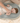 Parent changing baby on toddlekind baby foam changing pad nest pad sage with soft contoured support.
