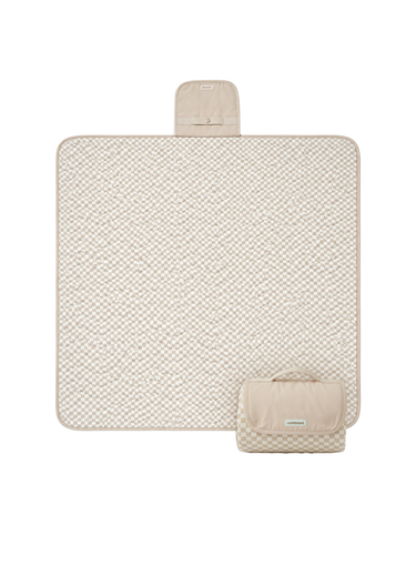 Flat lay product image of a floral play mat with a folded corner showing the underside, displaying the toddlekind portable water resistant wander classic play mat botanical earthen design and material. Alt Img