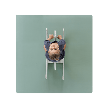 Overhead view of smiling toddler on ride-on toy on toddlekind baby toddler foam modern puzzle play mat classic moss. Alt Img
