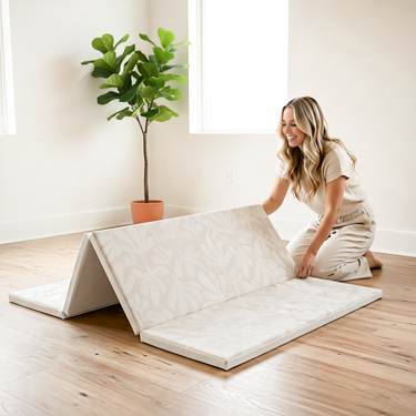 Parent setting up foldable mat on toddlekind baby toddler foldable foam cushioned tumble play mat willow ava in bright home.
