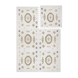 Interlocking foam tiles with lifted corner showing puzzle edges of the toddlekind baby toddler foam modern designer puzzle play mat haven amira golden clay.
