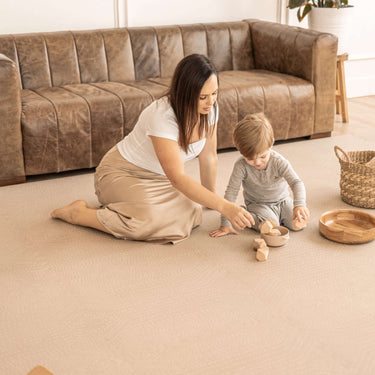 Mother and toddler playing with wooden toys on the toddlekind baby toddler foam modern designer puzzle play mat haven deco latte.
