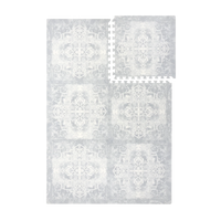 Interlocking foam tiles arranged together and one tile separated to show puzzle edges of the toddlekind baby toddler foam modern designer puzzle play mat haven parisa pearl blue.
