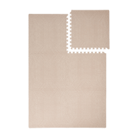 Interlocking foam tiles with one piece removed showing toddlekind baby toddler foam modern designer puzzle play mat haven deco latte.
