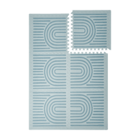 Interlocking tiles arranged in a grid with one piece lifted showing the toddlekind baby toddler foam modern designer puzzle play mat haven linear mineral.
