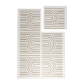 Interlocking foam tiles with one tile lifted to show puzzle edges of the toddlekind baby toddler foam modern designer puzzle play mat haven linear putty.