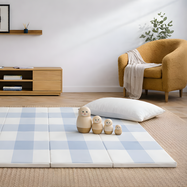 Styled living space with toddlekind baby toddler foldable foam cushioned tumble play mat arden tide and soft decor.
