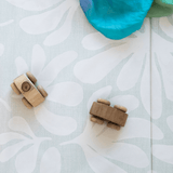 Close-up of textured surface with toy on toddlekind baby toddler foldable foam cushioned tumble play mat willow frost.
