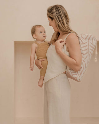 Mother holding baby with drawstring carry bag over shoulder – toddlekind portable water resistant wander classic play mat ocean sea shell for easy portability
