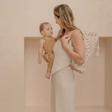 Mother holding baby with drawstring carry bag over shoulder – toddlekind portable water resistant wander classic play mat ocean sea shell for easy portability
