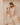 Mother sitting with baby and carrying folded play mat bag, toddlekind portable water resistant wander classic play mat ocean tan for easy transport
