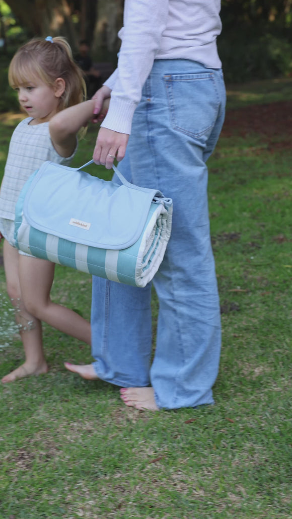 Mykonos video, mom with girl preparing for a picnic with their wander mat grande Mykonos